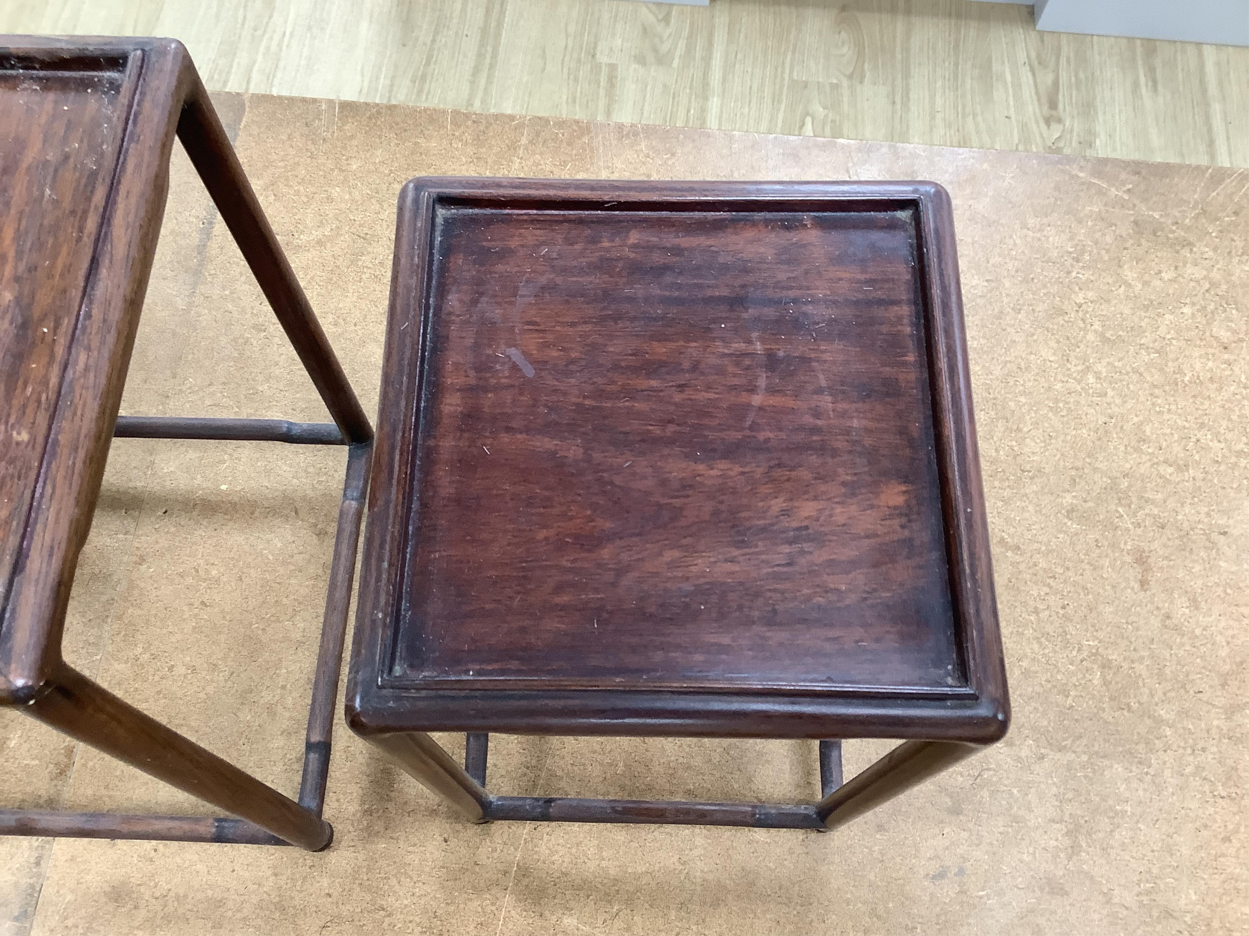 A nest of five Chinese hardwood stands, tallest (largest) 32cm high